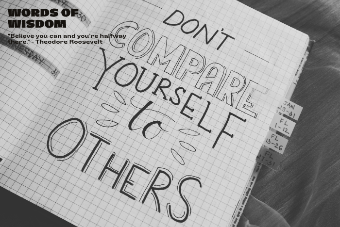 Book with text to not compare to others and other words of wisdom.